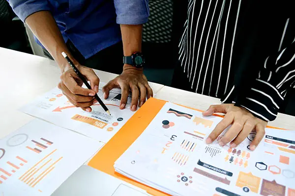 People interpreting paper copies of graphs.