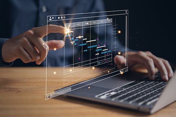 A person pressing on a futuristic hologram screen rising from a laptop keyboard