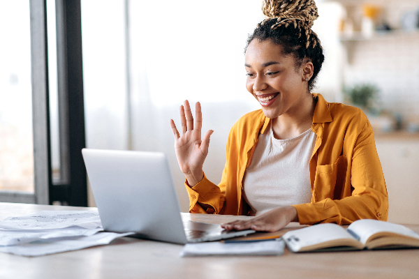 A woman talking to someone on her laptop