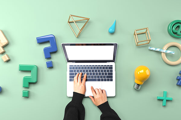 Hands typing on a laptop surrounded by colourful 3D question marks, lightbulb, and geometric shapes, symbolizing creativity and problem-solving in online learning.